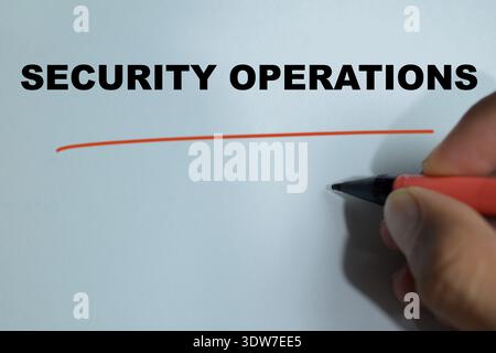 Concept of security operations write on book isolated on Wooden Table. For cybersecurity management, monitoring, IT systems defense and enterprise net Stock Photo