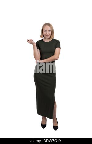 Beautiful woman in long black dress pointing aside in studio Stock Photo