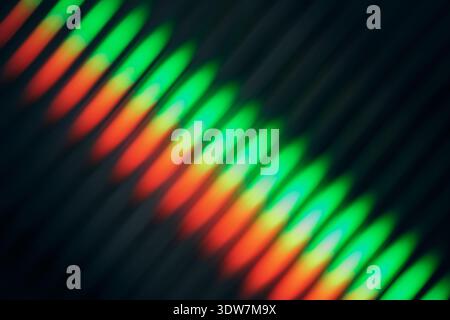 Blurred ribbed glass with Light refraction forms red, orange, yellow and green diagonal lines Stock Photo