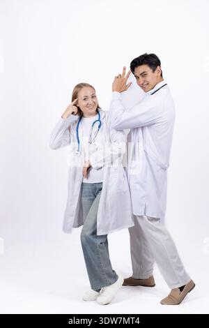 Team of two young doctors posing together in hospital Stock Photo