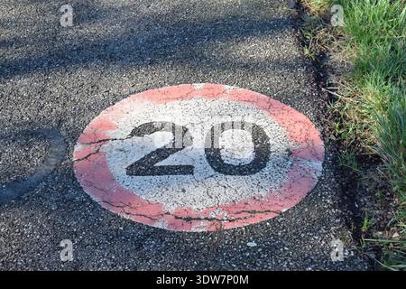 weathered old limit 20 sign on the ground Stock Photo