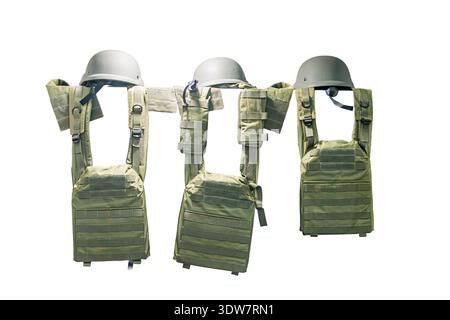 Olive green military vests with pockets and straps arranged in two rows on a neutral background, shown from the front against even lighting Stock Photo
