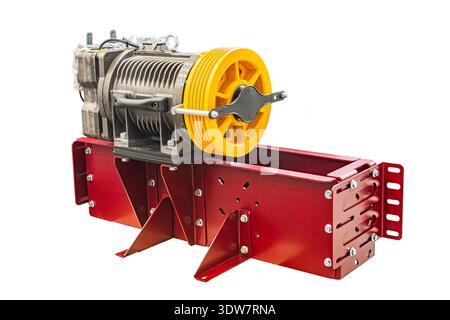 Industrial machine with red and yellow components, mounted on a metal frame, featuring complex functionality and high performance capacity The image d Stock Photo
