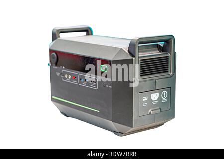 Indoor scene of a black, rectangular power station on a neutral gray background Features multiple ports AC outlets, DC outputs, USB and cooling vents Stock Photo