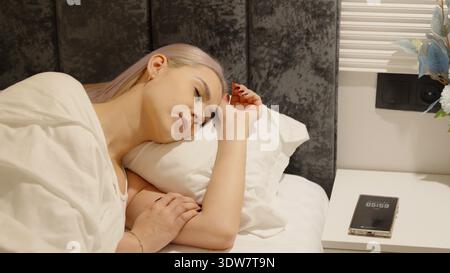 Woman sleeping peacefully in bed at home Stock Photo