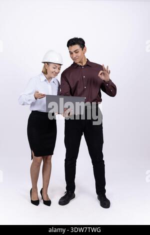 Two business people in formal wear looking at camera Stock Photo
