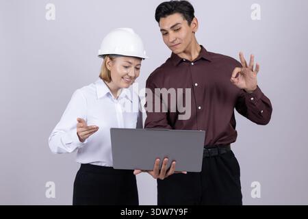 Two workers in formal shirts using laptop in studio Stock Photo