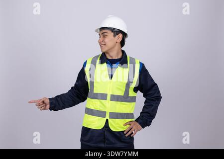 Worker in helmet and safety vest looking at camera Stock Photo