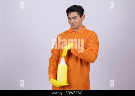 Man in orange work uniform holding yellow cleaning cloth Stock Photo