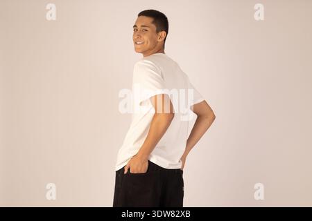 Back view of man in white t-shirt looking over shoulder Stock Photo