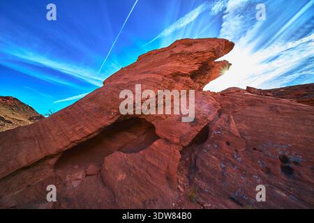 Red Sandstone Eagle Formation Sunburst and Dramatic Sky in Nevada Desert Landscape Stock Photo