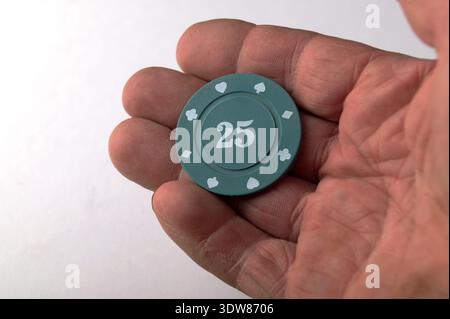Aces playing cards with a usd 25 casino chip on a white background. Stock Photo
