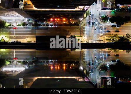 Overhead view of Miami city traffic at night reflected off high-rise building windows Stock Photo