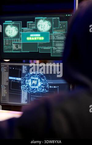 Cybercriminal coding on PC getting access granted message, evading security with stealth malware. Evil man successfully making script hiding malicious code from detection systems Stock Photo