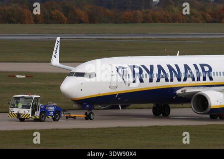 Blue Handling aircraft tug moving a Ryanair Boeing 737 to their maintenance hanger from the terminal buildings, London Stansted Airport, Essex, UK Stock Photo