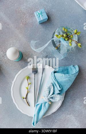 Easter Place Setting with Blue Napkin and Ribbon Stock Photo