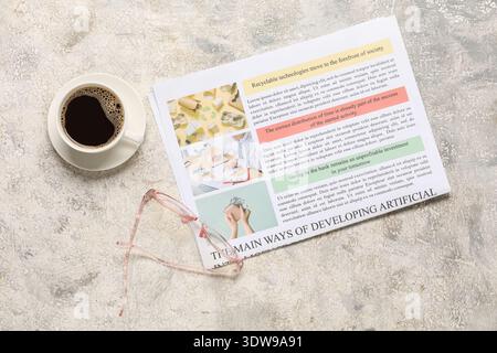 Newspaper with glasses and cup of coffee on grey grunge background Stock Photo