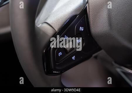 Close up of steering wheel control buttons inside car. Stock Photo