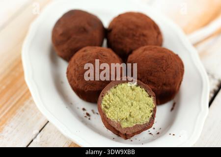 Close Up The Dubai Chewy Cookie or Dujjonku, Viral Dessert made from Chewy Mashmallow with Chocolate filled with Rich Pistachio Paste and Kataifi Fill Stock Photo