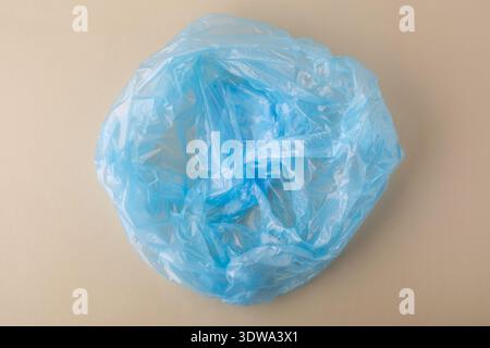 Blue crumpled plastic bag representing waste and environmental pollution Stock Photo
