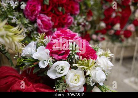 Beautiful romantic bouquet of artificial red, pink, and white flower for special celebration. This lovely decoration creates feeling of joy and vibran Stock Photo