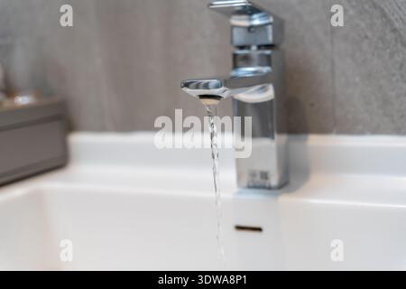 Save water. Forgot turning off the running water in the bathroom, protect environment. Greening planet, reduce global warming, Save world, life, futur Stock Photo