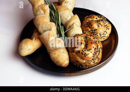 Assorted bakery products including loafs of bread and rolls Stock Photo