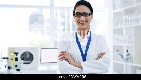 Portrait, woman or scientist with arms crossed in lab for research, development or microbiology. Biologist, science and happy person with confidence Stock Photo