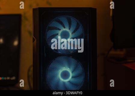 A powerful gaming PC computer at home with powerful fans and lights. Stock Photo
