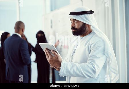 Arabic, man and thinking with tablet in office for market insight, trading decision or planning. Staff, global islamic trader and thoughtful with tech Stock Photo