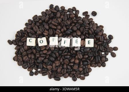 COFFEE white cube text on white background AND coffee beans background Stock Photo