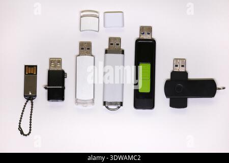 A top-down view of several diverse USB flash drives, showcasing different designs and materials, symbolizing essential digital storage solutions and p Stock Photo