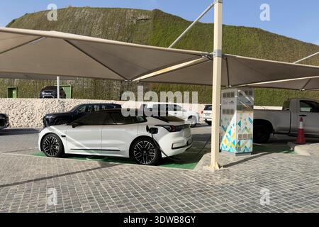 Doha, Qatar - Electric battery car charge at EV station. concept of EV car and home charging station. Electric car charging. Stock Photo
