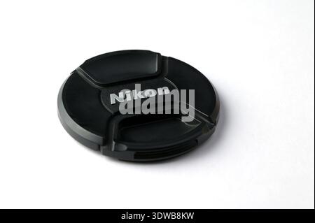Lviv, Ukraine. 30 March 2024.Nikon lens cap on white background. nikon lens cap with black logo on a white background. Stock Photo