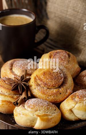 Still life with a cinnamon buns rolls and cup of coffee. Swedish kanelbulle Stock Photo