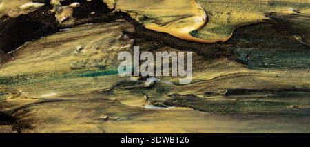 Abstract fluid art with gold green and black marbled acrylic paint texture Stock Photo