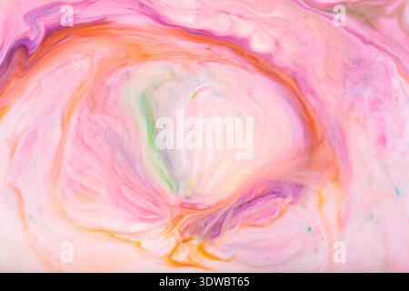 Soft pastel pink and orange abstract marble swirl pattern with fluid motion effect Stock Photo