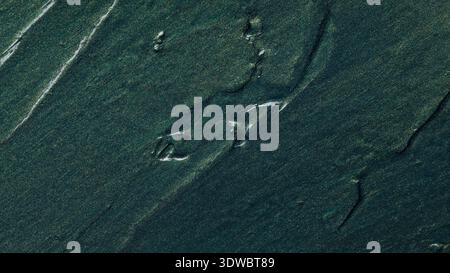 Dark teal abstract paint texture with diagonal brushstrokes and gradient effect Stock Photo