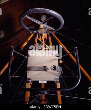 Curtiss D-III Headless Pusher (1912) was an American pusher biplane developed by the G.H. Curtiss Manufacturing Company and powered by a 50-horsepower Curtiss V-8 engine. The Headless variant eliminated the forward elevator after an accident involving exhibition pilot Lincoln Beachey. The archival image documents the fabric-covered airframe with rear elevators, orange struts, and wheeled landing gear. Stock Photo