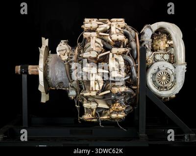 Mitsubishi Ha 42 Model 41 Ru (Ha 214 Ru) is a Japanese World War II eighteen-cylinder, two-row, air-cooled radial aircraft engine rated at 1,715 kW (2,300 hp) at 2,500 rpm, with 54.1 liters displacement and two-speed reduction gearing. The historical photograph documents the reciprocating powerplant mounted on a stand with specified bore, stroke, and supercharging features. Stock Photo