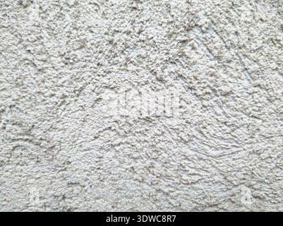 A high-resolution close-up of a textured white wall. This granular plaster finish provides a clean, neutral, and professional background for architect Stock Photo