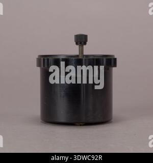 Simple Altimeter was a barometric aircraft instrument produced by United States Gauge Company to measure altitude from 0 to 20,000 feet within a compact 3-1/8 inch case. The archival image documents the brown circular face, white graduations, and adjustment control as a historical photographic print for equipment reference. Stock Photo
