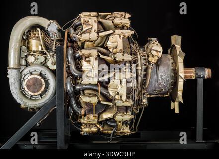 Mitsubishi Ha 42 Model 41 Ru (Ha 214 Ru) is a Japanese World War II eighteen-cylinder, two-row, air-cooled radial aircraft engine rated at 1,715 kW (2,300 hp) at 2,500 rpm, with 54.1 liters displacement and two-speed reduction gearing. The historical photograph documents the reciprocating powerplant mounted on a stand with specified bore, stroke, and supercharging features. Stock Photo