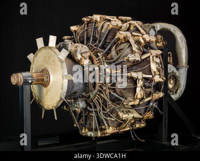 Mitsubishi Ha 42 Model 41 Ru (Ha 214 Ru) is a Japanese World War II eighteen-cylinder, two-row, air-cooled radial aircraft engine rated at 1,715 kW (2,300 hp) at 2,500 rpm, with 54.1 liters displacement and two-speed reduction gearing. The historical photograph documents the reciprocating powerplant mounted on a stand with specified bore, stroke, and supercharging features. Stock Photo