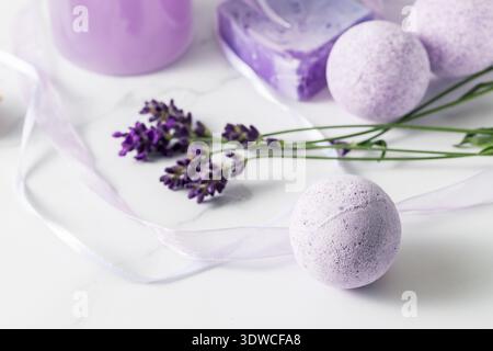 Aroma bath ball bomb with lavender extract for relaxation on marble background. Home spa and wellness Stock Photo