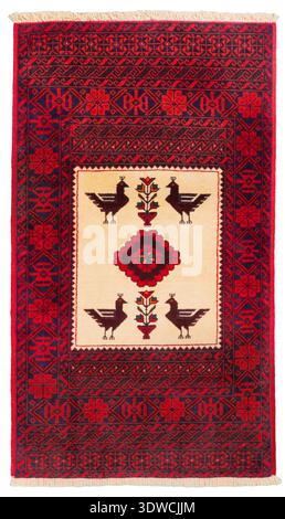 classic, hand-knotted Baluchi rug featuring stylized bird and "tree of life" motifs on an ivory central panel, framed by a geometric border in deep re Stock Photo