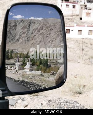 Stupas in Ladakh seen from side view mirror of a car : road trip and travel concept in the Himalayas Stock Photo