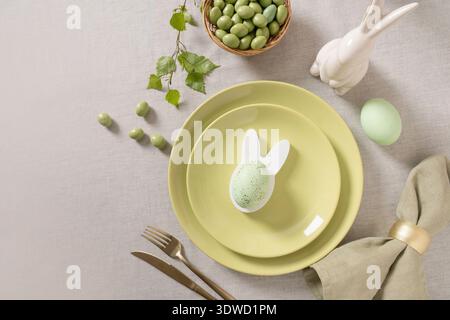 Easter table with green candy almonds and bunny decor Stock Photo