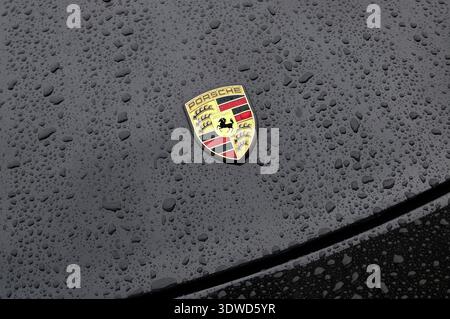 raindrops on black porsche sports car bonnet Stock Photo
