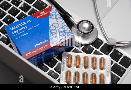 Tamfrex XL capsules on doctor's laptop computer keypad and stethoscope Stock Photo